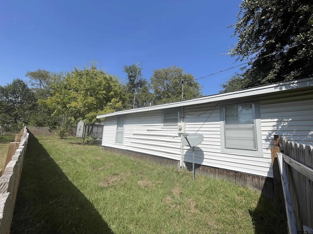 view of side of property with a lawn