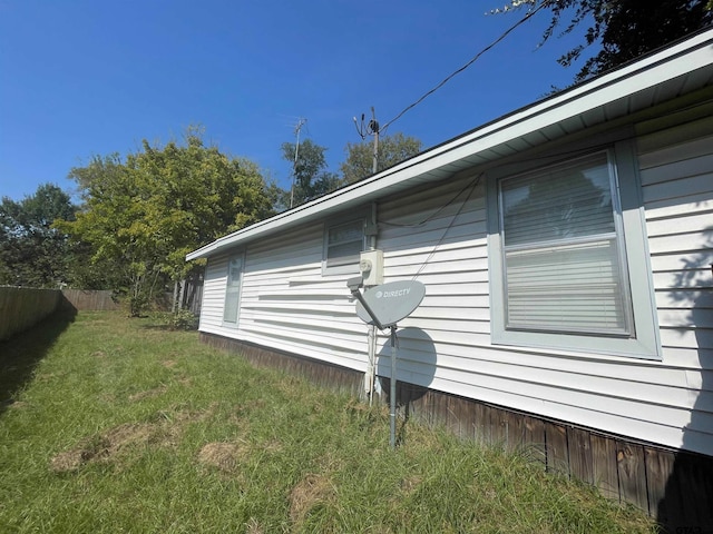 view of home's exterior with a yard