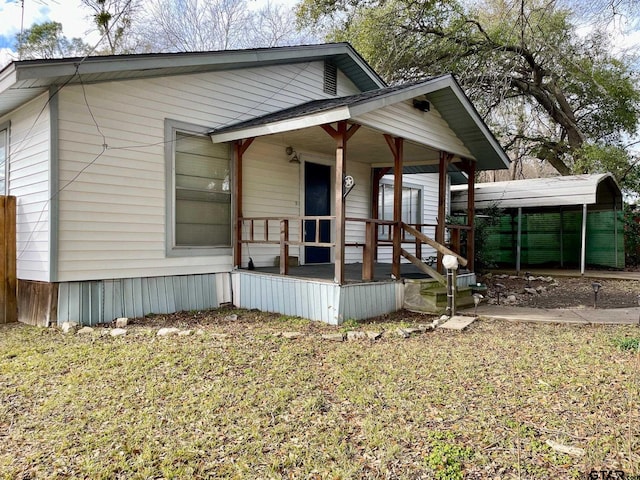 view of front facade featuring a carport and a porch