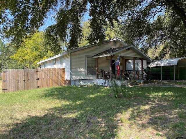 view of front facade with a carport and a front lawn