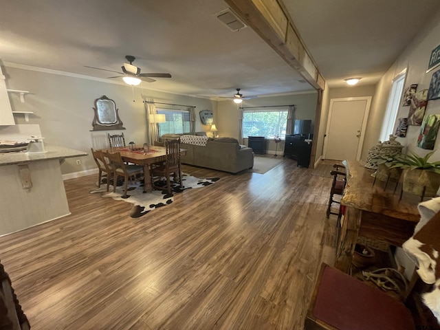 living room featuring ornamental molding and dark hardwood / wood-style flooring