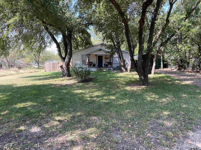 view of yard with a porch and a shed