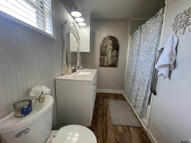 full bathroom with vanity, wood-type flooring, toilet, and shower / bath combo with shower curtain