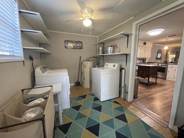 clothes washing area with crown molding, dark hardwood / wood-style floors, ceiling fan, washer and clothes dryer, and water heater