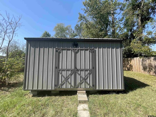 view of outbuilding featuring a yard