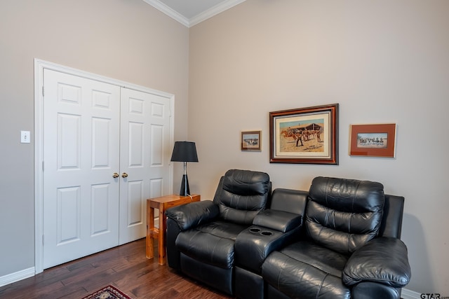 home theater room featuring dark hardwood / wood-style floors and ornamental molding