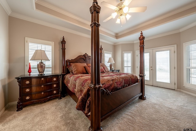 carpeted bedroom with ceiling fan, french doors, a raised ceiling, crown molding, and access to outside