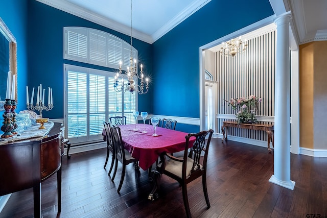 dining room with decorative columns, dark wood-type flooring, a chandelier, and ornamental molding