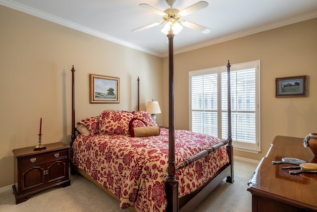 carpeted bedroom featuring ceiling fan and crown molding