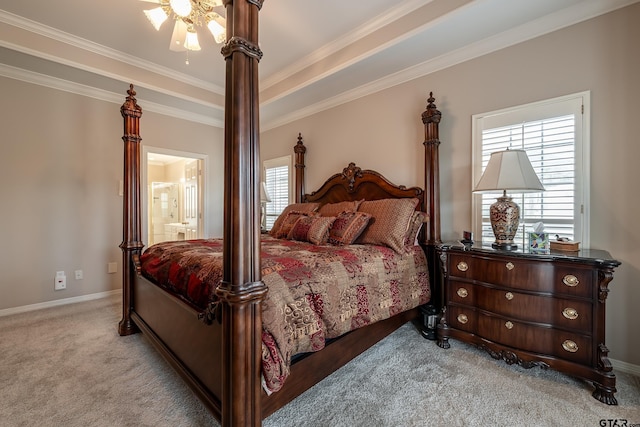 carpeted bedroom with ceiling fan, ornamental molding, multiple windows, and ensuite bath