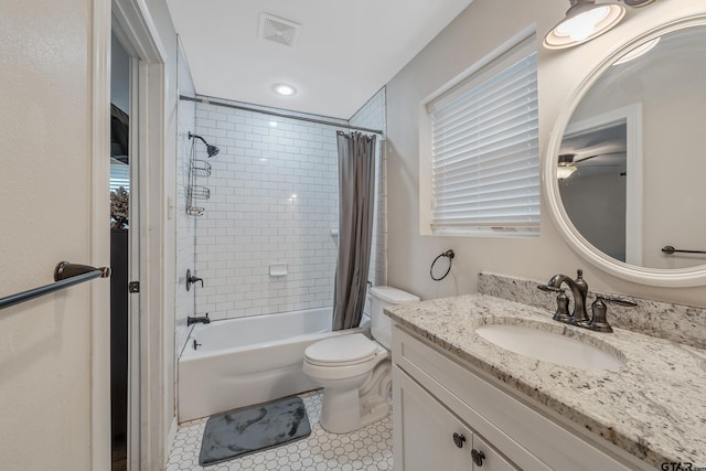 full bathroom featuring tile patterned floors, vanity, shower / bath combo, and toilet