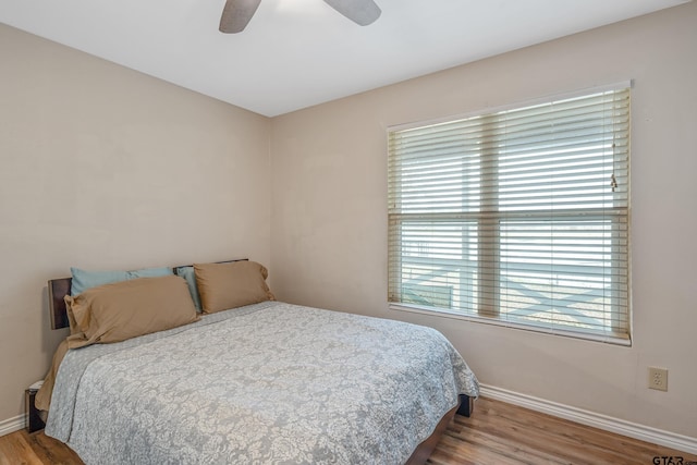 bedroom with light hardwood / wood-style floors and ceiling fan