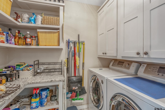 laundry area with cabinets and washing machine and clothes dryer