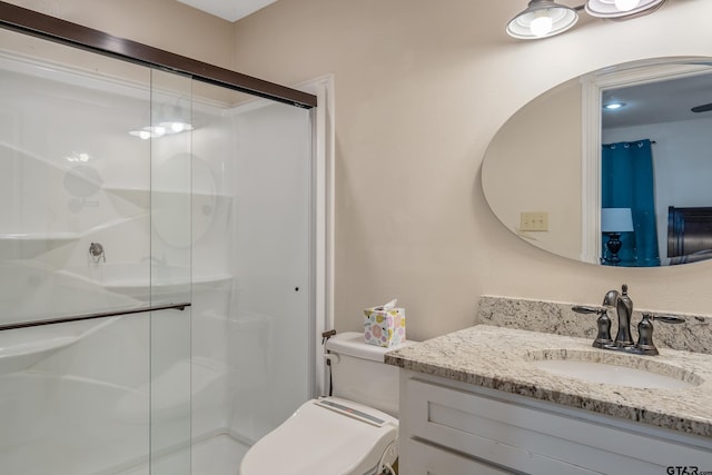 bathroom with vanity, toilet, and walk in shower