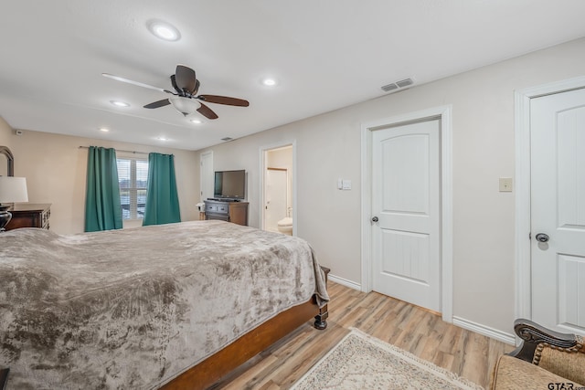 bedroom featuring light wood-type flooring, ensuite bathroom, and ceiling fan