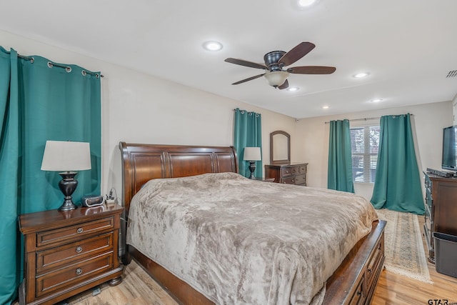 bedroom with light wood-type flooring and ceiling fan