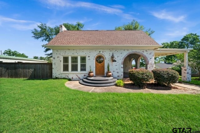 rear view of house with a lawn