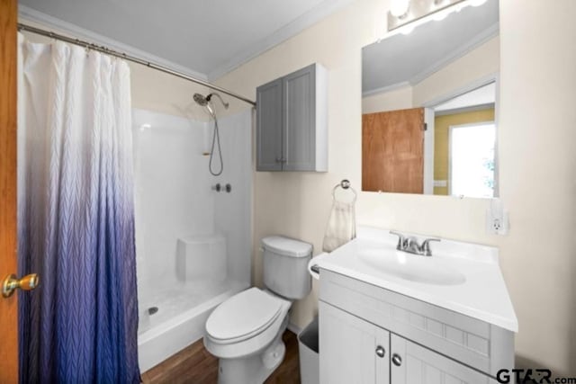 bathroom featuring hardwood / wood-style floors, toilet, curtained shower, and crown molding