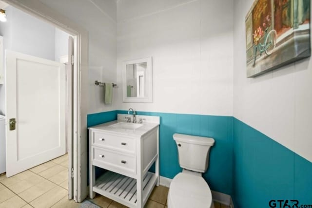 bathroom featuring tile patterned flooring, vanity, and toilet