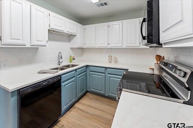 kitchen with sink, blue cabinetry, black appliances, light hardwood / wood-style floors, and white cabinets