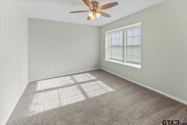 carpeted spare room with ceiling fan