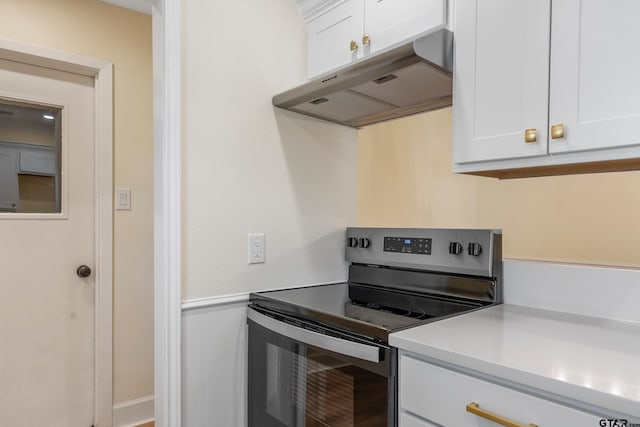 kitchen with white cabinetry and electric stove