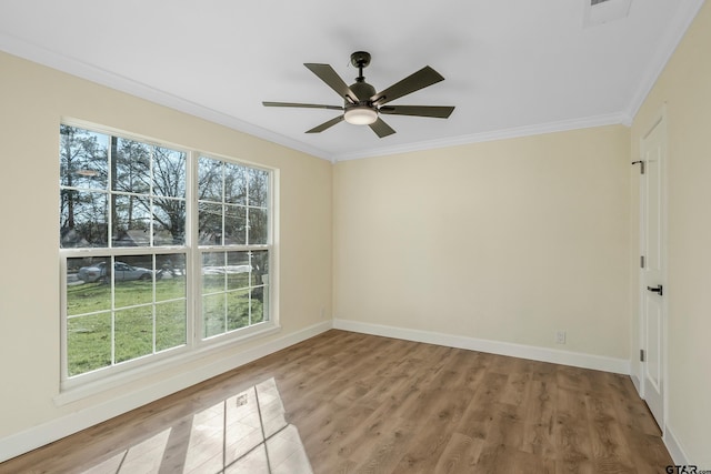 spare room with hardwood / wood-style floors, ceiling fan, and ornamental molding