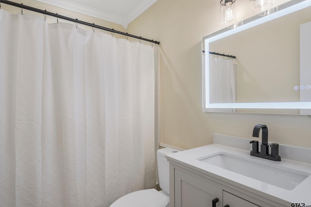 bathroom featuring toilet, vanity, and ornamental molding