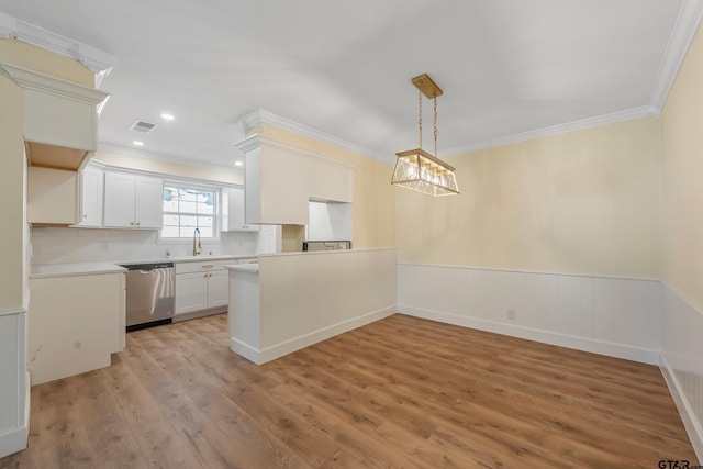 kitchen with decorative backsplash, white cabinets, ornamental molding, sink, and dishwasher