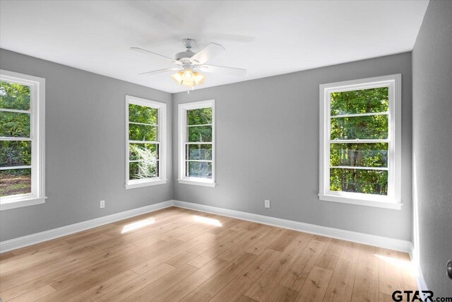 106 Peterson Pl, Longview, TX 75602 - empty room with healthy amount of natural light, a ceiling fan, and light wood-style floors