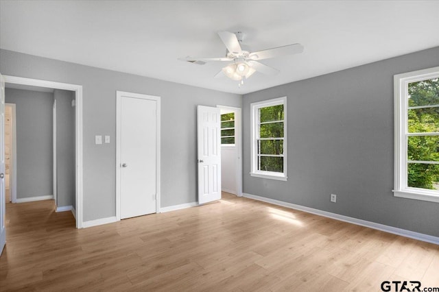 106 Peterson Pl, Longview, TX 75602 - unfurnished bedroom featuring light wood-style floors and a ceiling fan