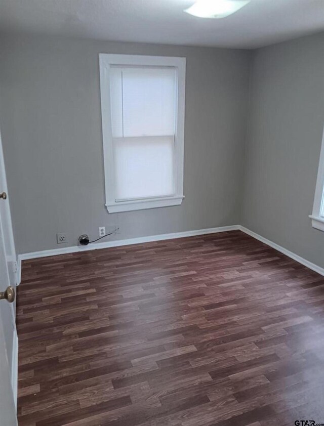 7094 Eleanor St, Tyler, TX 75708 - empty room featuring dark wood-style floors and baseboards