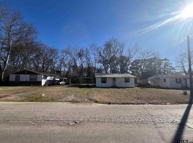 7094 Eleanor St, Tyler, TX 75708 - ranch-style house featuring a carport and metal roof