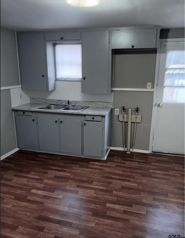 7094 Eleanor St, Tyler, TX 75708 - kitchen with a sink, dark wood-style floors, light countertops, and baseboards