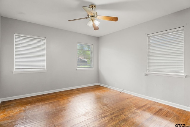 2811 Rollingwood Dr, Tyler, TX 75701 - unfurnished room with wood-type flooring, baseboards, and a ceiling fan