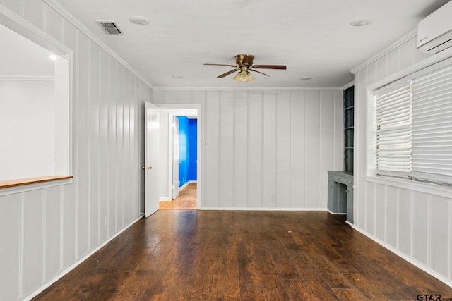 2811 Rollingwood Dr, Tyler, TX 75701 - empty room featuring a wall unit AC, a ceiling fan, ornamental molding, wood-type flooring, and a decorative wall