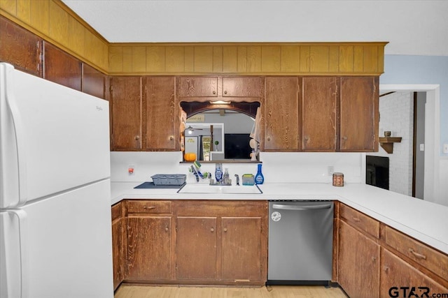 kitchen with sink, stainless steel dishwasher, and white refrigerator