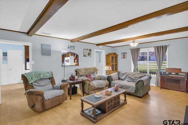 living room with beam ceiling and light wood-type flooring