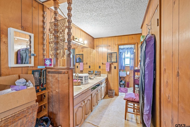 bathroom featuring vanity, crown molding, and wooden walls