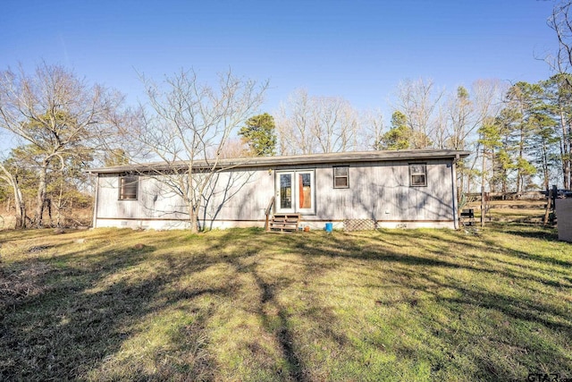 back of house with a lawn