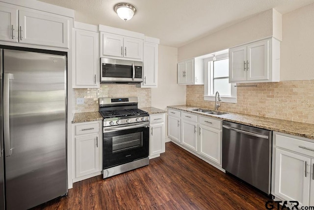 kitchen with dark hardwood / wood-style floors, white cabinetry, sink, and appliances with stainless steel finishes