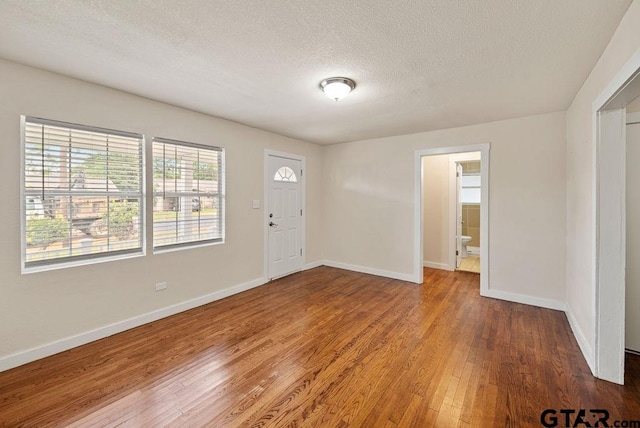 entryway featuring a textured ceiling and hardwood / wood-style flooring