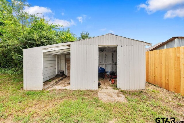 view of outbuilding with a yard