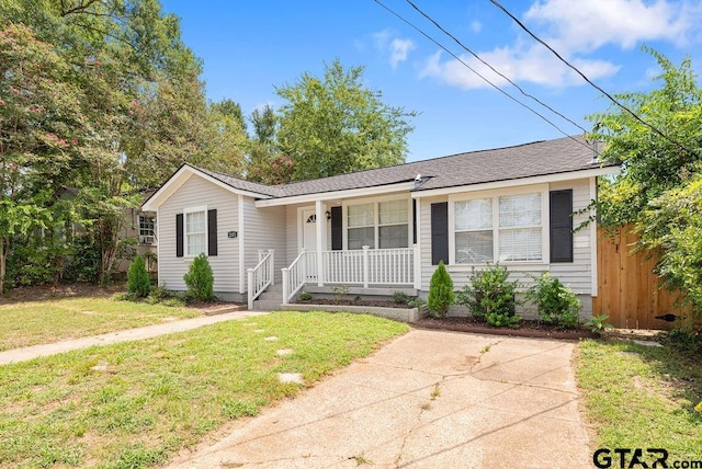 ranch-style house featuring a porch and a front yard