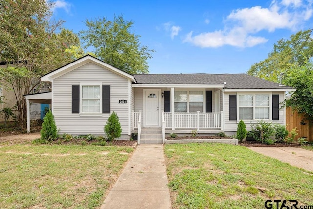 ranch-style home with a front yard and covered porch