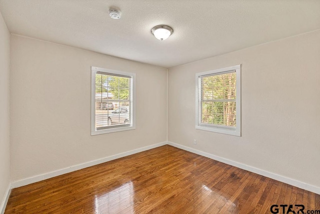 unfurnished room featuring hardwood / wood-style floors