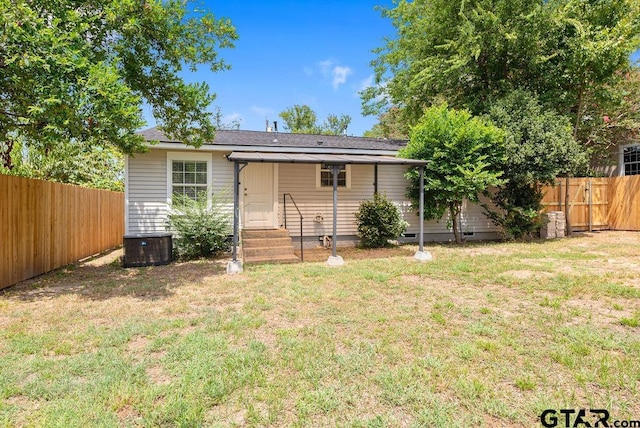 rear view of property featuring a yard