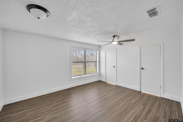1005 N Rodeo St, Gladewater, TX 75647 - unfurnished bedroom with a textured ceiling, wood finished floors, baseboards, and a ceiling fan