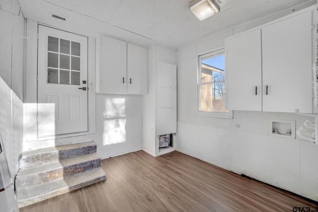 1005 N Rodeo St, Gladewater, TX 75647 - kitchen featuring white cabinets and wood finished floors
