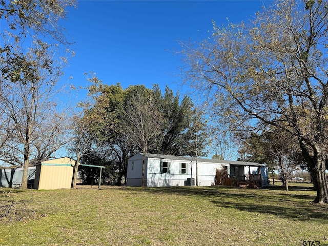 view of yard featuring an outbuilding and a carport